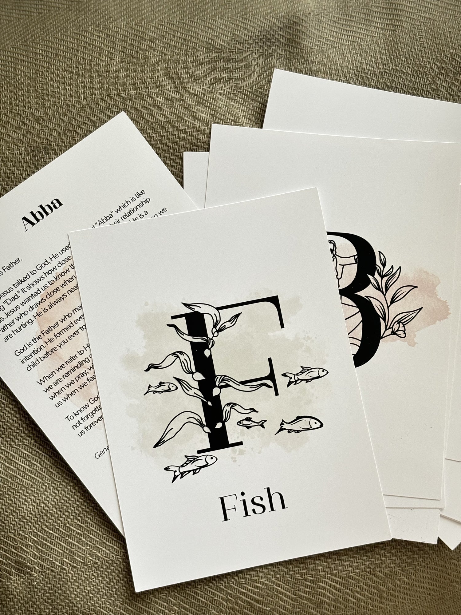 Set of greeting cards with fish illustrations and text on a textured surface